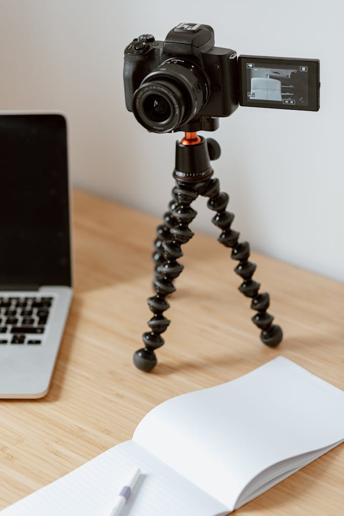 Camera on tripod recording video on table